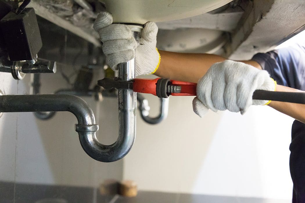 Plumber fixing a pipe